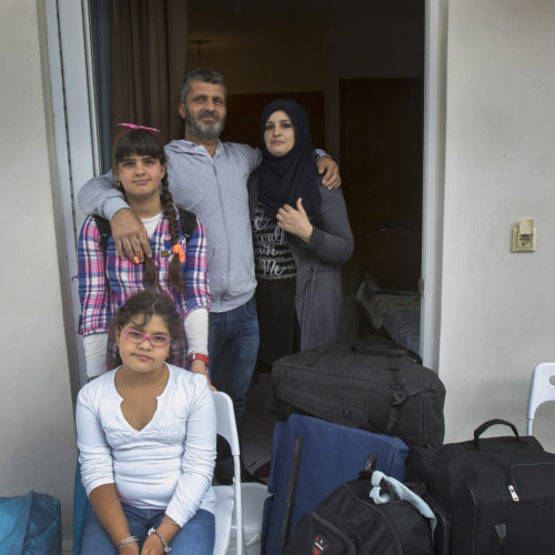 ATHENS, GREECE (EU) 05-29-2017: The Al Rahmoun family arrive at their new apartment in Athens after living in a refugee squat in an abandoned school building for the past few months. They are being sponsored by two sisters in New York who raised money for them through HumanWire's Tent-to-Home Project, the new apartment is a welcome relief from the refugee camps they had been living in, one with conditions so dire that the mother, Manar, had resorted to sucking on the ears and faces of her children to keep them clean. They found the new apartment so blessed, it was “like a wedding feeling,” Hosam said, a place where their children liked sitting in the bathtub. The Al Rahmoun's fled the war in Syria and have been refugees for over a year, and are now awaiting a ruling on their asylum application in Greece (EU).