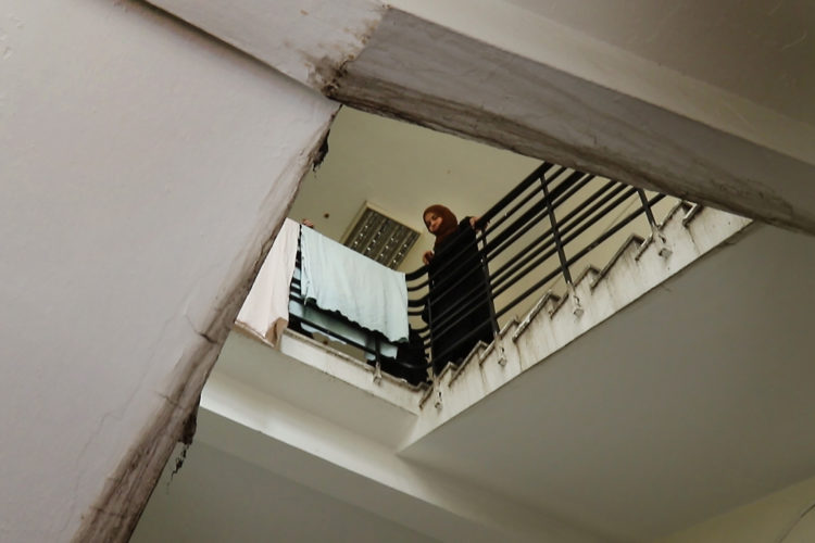 ATHENS, GREECE (EU) 05-29-2017: Manar Al Rahmoun calls down to her husband from the upper floor as the family moves out of the refugee squat in an abandoned school building in Athens, where they have been living for the past few months. The Al Rahmouns are being sponsored by two sisters in New York who raised money for them through HumanWire's Tent-to-Home Project.