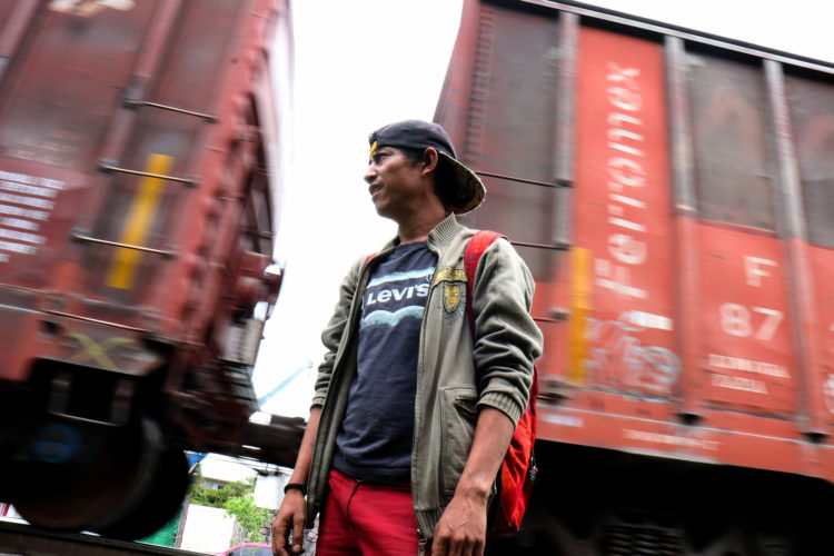 GUADALAJARA, MEXICO  07/11/2017: Enrique, a migrant from Honduras, waits for the right moment to jump aboard a moving freight train, known as La Bestia, in Guadalajara. Migrants use the freight trains on their journey to the United States to more quickly traverse the length of Mexico. This mode of travel is extremely dangerous and illegal. Guadalajara, roughly the midway between Central American and the U.S. border. Enrique says this this his 4th attempt to make it into the U.S., previous attempts resulted in being deported back to Honduras. If he makes it across, he plans to look for his a half-sister living in Trenton, NJ.

The journey to the United States is often long and involves several steps. Before migrants can get on the train they must travel from their homes through Central America to the Mexican border. Crossing the border is relatively easy as, even with increased surveillance, it is lightly patrolled and wide sections remain porous. Once in Mexico, migrants must then travel on foot or by vehicle to the nearest train terminal, where, usually after paying bribes or protection fees, they climb atop a railcar to start the first leg of their journey north. The travelers frequently change train lines along the way, often stopping at shelters run by civil-society organizations. Once they near the U.S. border migrants disembark and pay a smuggler (known as a “coyote”) to enter the United States. As the trains are subject to inspection and surveillance close to the border, it is nearly impossible for a migrant to cross the U.S.-Mexico border aboard the train.