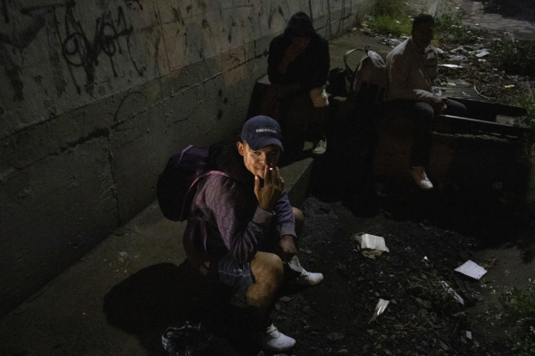 GUADALAJARA, MEXICO   07/13/2017  A group of Honduran men take a break along the railroad tracks in Guadalajara, where wild dogs and gang members lurk in the shadows, as they continue on the journey to the U.S. border. After leaving the nearby FM4 shelter, the men walked along the railroad tracks to a position where they wait to jump on board La Bestia, the moving freight train known as The Beast. 

According to the Migration Policy Institute (MPI), a half a million Central American immigrants ride atop La Bestia during their long and perilous journey through Mexico to the U.S. The migrants often must latch onto the moving freights, which run along multiple lines, carry products north for export, and must ride atop the moving trains, facing physical dangers that range from amputation to death if they fall or are pushed. Beyond the dangers of the trains themselves, Central American migrants are subject to extortion and violence at the hands of the gangs and organized-crime groups that control the routes north.



The migrant shelter provides a clean and safe place for migrants to rest, wash and eat, while volunteers from non-governmental organizations offer clean clothes, medical attention, and free legal and psychological counseling. 

M4 Paso Libre was started by a group of students in 2007 and opened its first kitchen and day shelter in 2010. The nonprofit is a member of the Office of the United Nations High Commissioner for Refugees (UNHCR), assists approximately 8,000 migrants each year, and relies on regular donations and hundreds of volunteers to support the migrants who pass through.