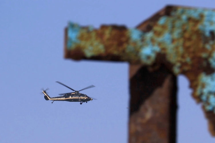 TIJUANA, MEXICO  03-14-2019:A CBP helicopter flies past the border wall shortly after a group of migrants pushed their way through the fence and ran north along the beach into the United States. They were later captured by United CBP agents, who said they arrested about 52 migrants, including 23 men, between the ages of 18 to 53, 12 women aged 21 to 50, and 17 minors between the ages of 1 and 14 years old. They were mostly from Honduras and came to Tijuana in a caravan. As they broke through the fence and ran down the beach, some dropped clothes and shoes from the backpacks, as some people on the Mexico side cheered them on.