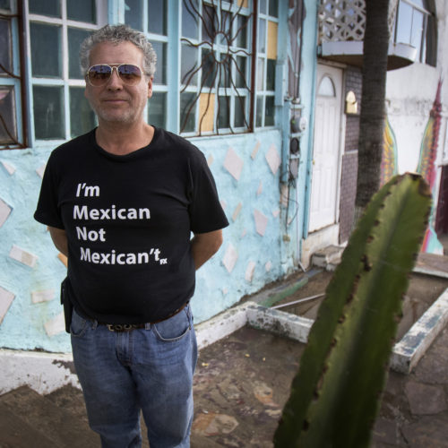 TIJUANA, CA 03/12/2019:  Border Angels volunteer Miguel Barraza wears a tee shirt wears a "I'm Mexican, not Mexican't" tee shirt outside the office La Playa, in Tijuana.
Border Angels is a nonprofit that has been leading humanitarian efforts such as “water drops” in the desert for migrants for over 20-years. In 2019, two border aid volunteers were sentenced to 15 months of probation, must pay fines for dropping off water and food intended for migrants crossing through a protected desert area in southern Arizona.