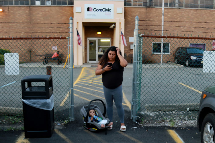 NEWARK, NJ  08-08-2018  IMMIGRATION STORY: Kasandra Serrano, 21, waits with her 9-month old son Ismael as she calls an Uber outside the ICE Detention Center in Elizabeth to visit her fiancé who is in detention there. Her fiancé Daniel Castro Castro 28, was taken into custody by Newark Police in early June for an outstanding warrant, while out getting bottled water for baby formula, and now currently is being detained by ICE at the Elizabeth Detention Center. Castro is undocumented and is facing deportation to his native Nicaragua. The couple has a 9-month old baby boy, Ismael. Serrano says he doesn't know how she will support herself and baby Ismael if he is deported.