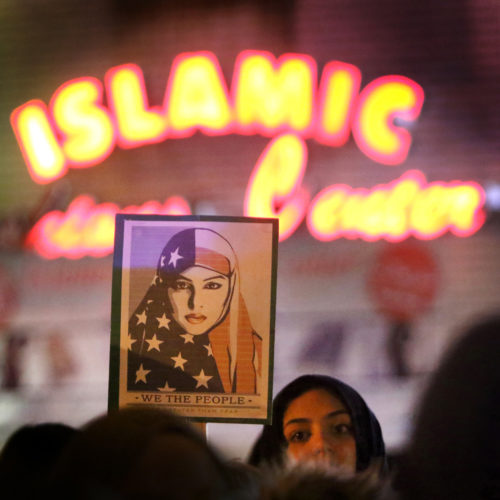 PATERSON, NJ  02/01/2017: A protester holds a "We the People" sign as protesters rally in South Paterson against President Donald Trump’s executive order to curtail entry into the U.S. from seven Middle Eastern and African countries. About 400 protesters converged in South Paterson's predominately Arab and Turkish American neighborhood to protest the order.