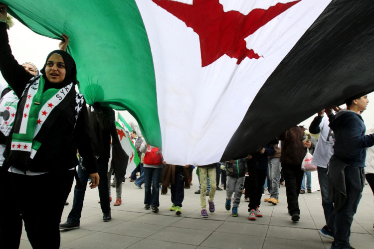 00015659A  WASHINGTON DC  03/20/2016   5TH ANNIVERSARY OF SYRIAN UPRISING: Supporters of the Syrian uprising carry a giant Syrian flag as they marched through the streets in Washington from the Lincoln Memorial to the The Ellipse, located near the White House, at the “March for Syrian Freedom” in Washington DC today. About a thousand people attended the rally, which commemorated the 5th anniversary of when the conflict began as an anti-government uprising with protesters taking to the streets on March 15, 2011, brings  attention to the global humanitarian crisis and raise money to aid Syrian refugees worldwide. The program included an interfaith conference at the Lincoln memorial, followed by a march to the White House. -photo by Thomas E. Franklin

Thomas E. Franklin
tomefran@gmail.com
Phone: 201-669-2075c