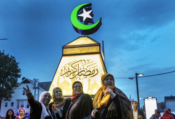 PATERSON, NJ  05-04-19: A group of Muslim women pose for Instagram photos with the giant fanous, or lantern, illuminated at the South Paterson Park on Main Street to usher in the holy month of Ramadan. After a ceremony led by Andre Sayegh, the city's first Arab-American mayor, people gathered to have their photo taken. 6th Ward Paterson Councilman Al Abdellaziz, who helped start the tradition four years ago, said, "We want this to become a destination, "it's like the Muslim Rockefeller Center Christmas tree."