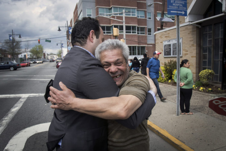 04-17-19 SOUTH PATERSON PROJECT/ MAYOR ANDRE SAYEGH:  Paterson mayor Andre Sayegh gets a big hug from a city resident. Sayegh is the first Arab-American to lead the city, which has had a long-thriving Middle Eastern immigrant community in the southern district of the city known as South Paterson. Sayegh’s was born to a Syrian mother and a Lebanese father, and is Christian, was a longtime city councilman and was elected mayor in 2018.